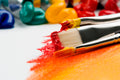 Close-up of paintbrush and acrylic paint pots