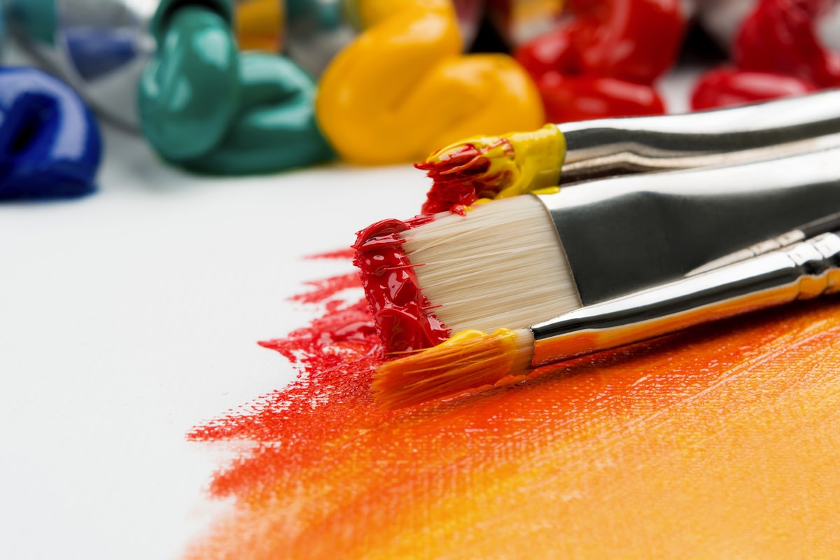 Close-up of paintbrush and acrylic paint pots